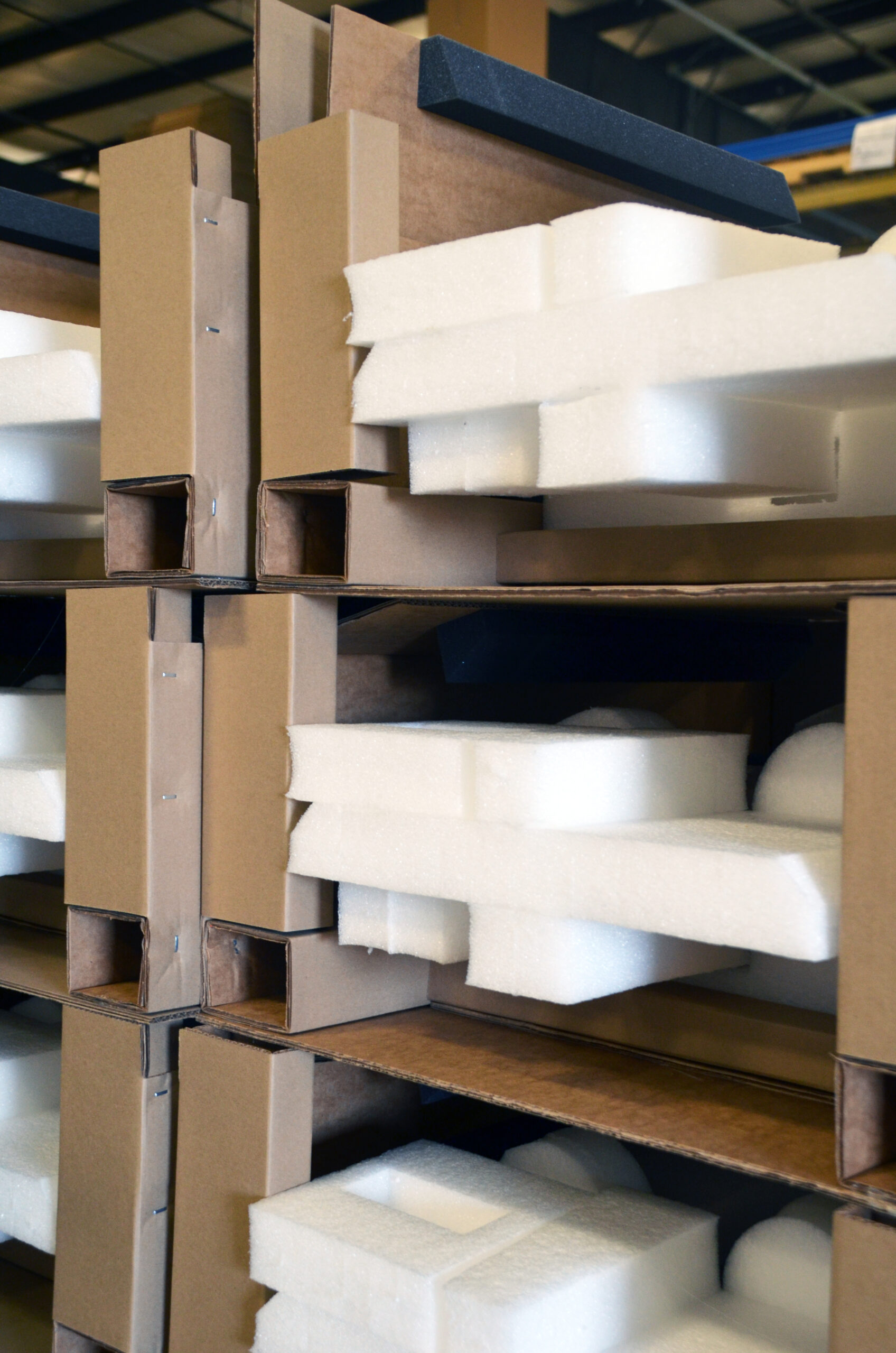 Stacked foam and cardboard hybrid packaging for transport.